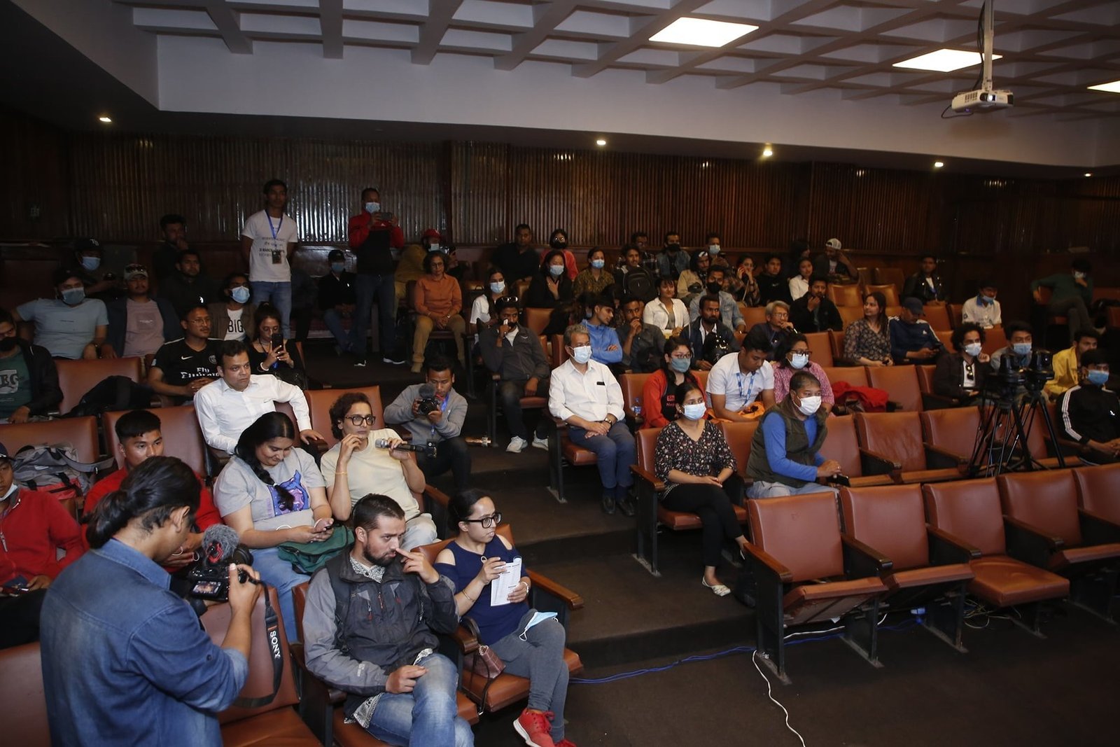 Filmmakers, press and students filling the auditorium at an NFCA programme in Kathmandu