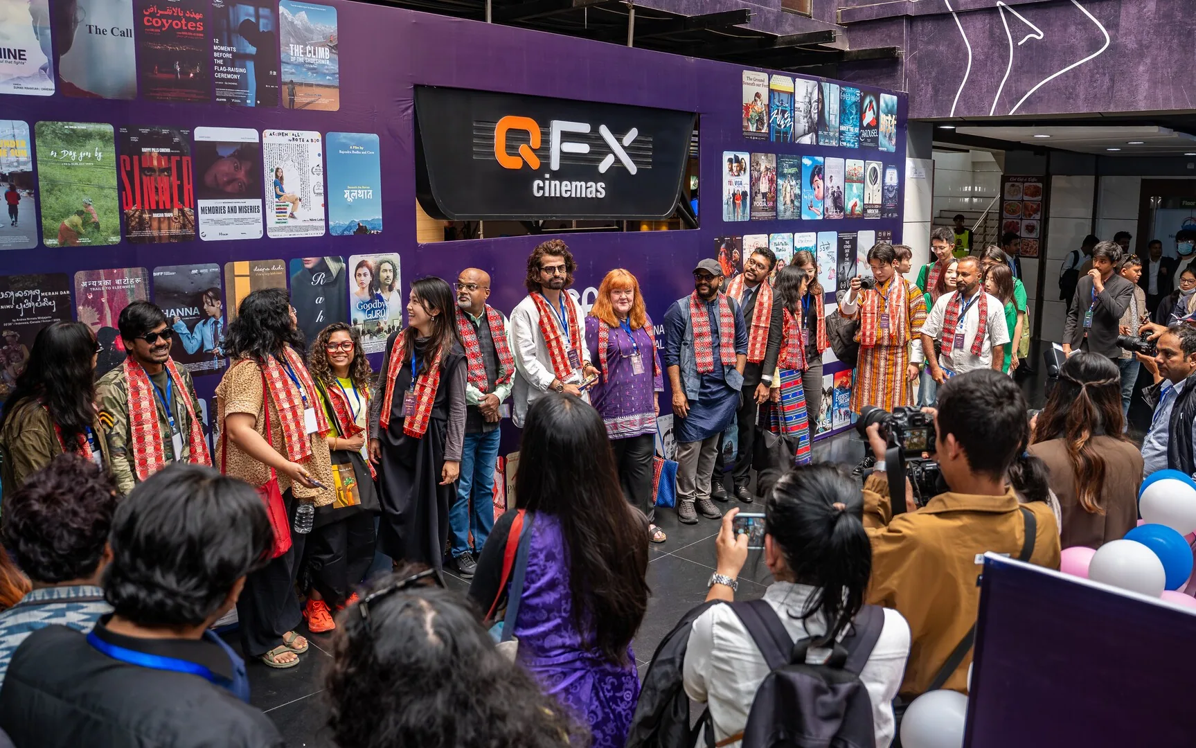 Filmmakers in traditional scarves lined up for photographs at the Nepal International Film Festival opening ceremony at QFX Cinemas, Kathmandu